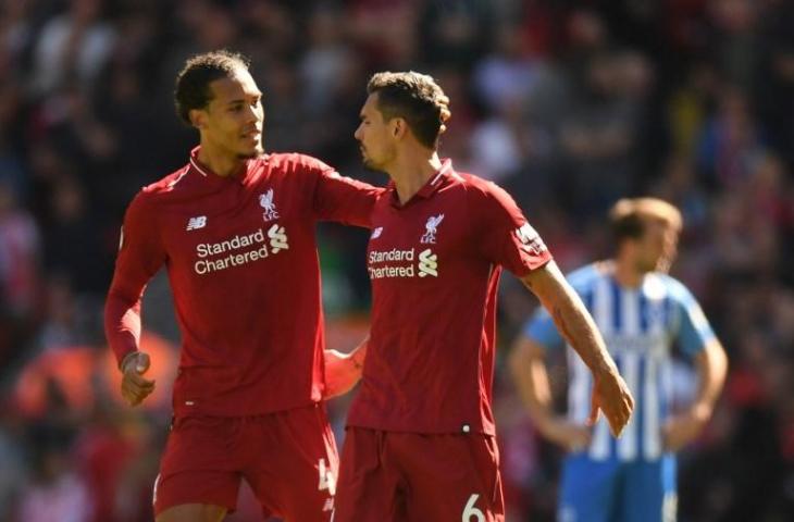 Virgil van Dijk dan Dejan Lovren saat berhadapan dengan Brighton and Hove Albion di Anfield pada 13 Mei 2018 (Paul Ellis/AFP)