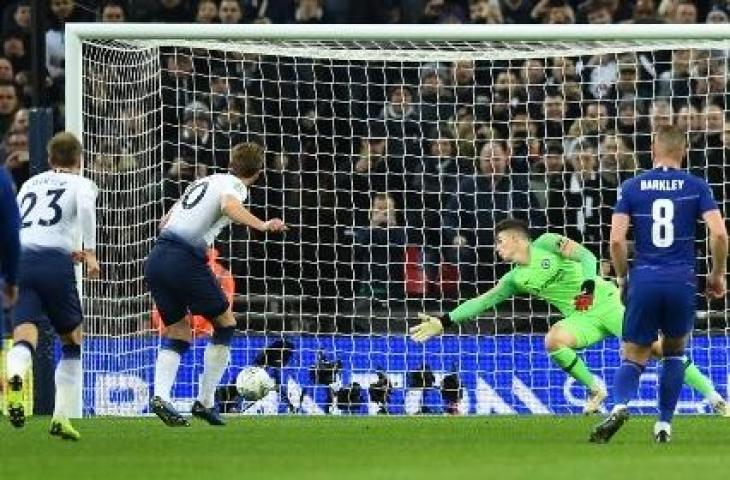 Aksi Harry Kane saat mencetak gol lewat titik putih ke gawang Kepa Arrizabalaga dalam laga Tottenham Hotspur vs Chelsea pada leg pertama semifinal Piala Liga Inggris (Carabao Cup) di Stadion Wembley, (8/1/2019. (GLYN KIRK / AFP)