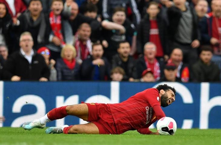 Mohamed Salah meringis kesakitan usai dilanggar pemain Leicester City dalam Liga Primer Inggris 2019/20 di Stadion Anfield, Sabtu (5/10/2019). [PAUL ELLIS / AFP]