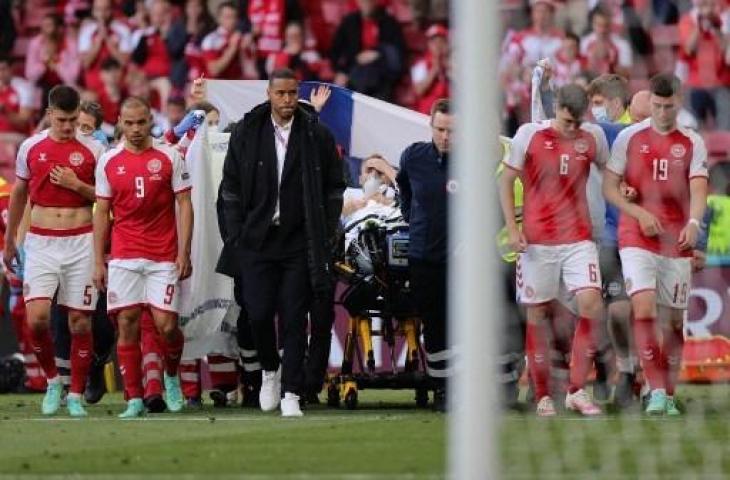 Gelandang Denmark Christian Eriksen ditandu keluar lapangan setelah sempat kolaps saat menghadapi Finlandia di laga Grup B Euro 2020 di The Parken Stadium, Kopenhagen. (FRIEDEMANN VOGEL / AFP / POOL)