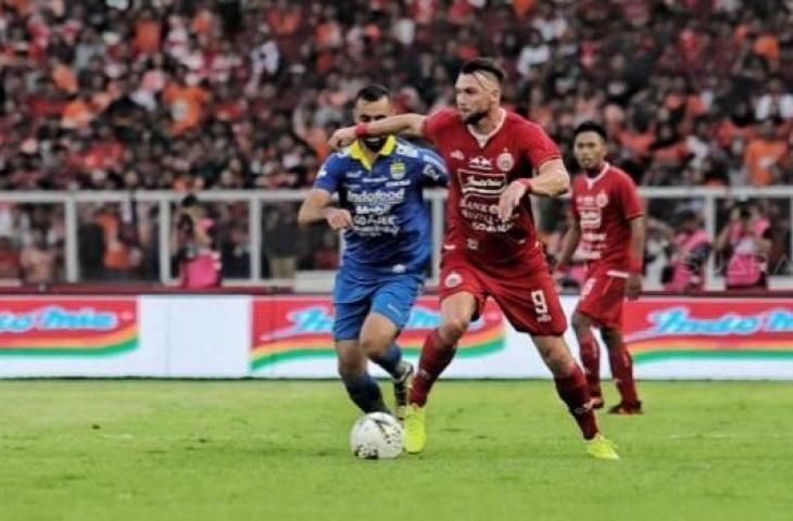 Striker Persija Jakarta Marko Simic dibayang-bayangi pesebakbola Persib Bandung di Stadion Utama Gelora Bung Karno (SUGBK), Senayan, Jakarta, Rabu (10/7). (Suara.com/Muhaimin A Untung)