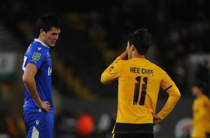 Bek Gillingham FC Elkan Baggott (kiri) berbicara dengan striker Wolverhampton Wanderers Hwang Hee-chan pada akhir pertandingan sepak bola putaran keempat Piala Liga Inggris di Stadion Molineux, di Wolverhampton, 20 Desember 2022. (AFP/Geoff Caddick)