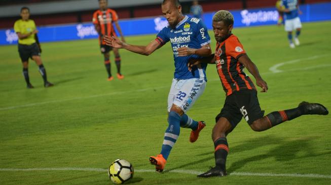 Kapten Persib Bandung, Supardi Nasir (kiri) berebut bola dengan pemain Perseru Serui, Kelvin Wopi, dalam lanjutan Liga 1 2018 yang berakhir 2- 2 di Stadion I Wayan Dipta, Gianyar, Bali, Jumat (23/11). [Antara/Nyoman Budhiana]