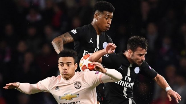 Striker belia Manchester United, Mason Greenwood (kiri) berjibaku dengan dua pemain Paris Saint-Germain pada laga leg kedua babak 16 besar Liga Champions 2018/2019 di Parc des Princes, Kamis (7/3/2019) dini hari WIB. [FRANCK FIFE / AFP]