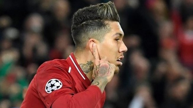 Gelandang Liverpool Roberto Firmino melakukan selebrasi setelah menjebol gawang Porto pada laga Liga Champions di Anfield. LLUIS GENE / AFP