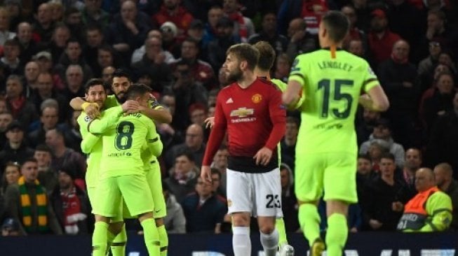 Luis Suarez dan para pemain Barcelona merayakan gol setelah bek MU Luke Shaw membuat gol bunuh diri saat laga Liga Champions di Old Trafford. 