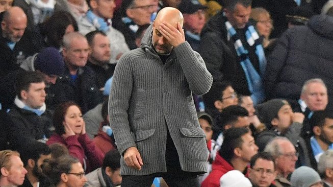 Ekspresi kekecewaan manajer Manchester City, Pep Guardiola pada laga leg kedua perempatfinal Liga Champions 2018/2019 kontra Tottenham Hotspur di Etihad Stadium, Kamis (18/4/2019) dini hari WIB/ [Anthony Devlin / AFP]