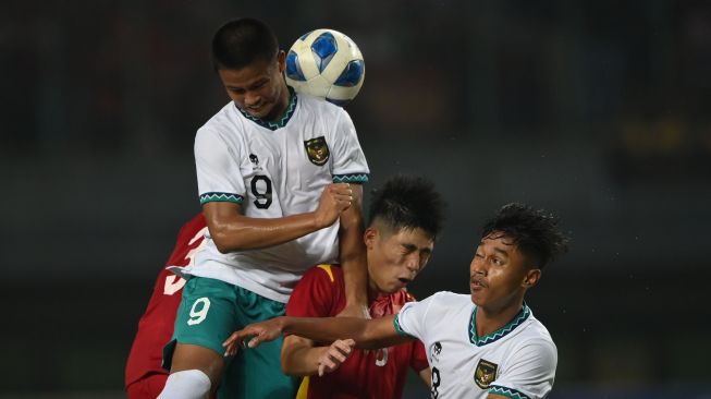 Pesepak bola Tim Nasional Indonesia U-19 Hokky Caraka (kiri) berebut bola dengan pesepak bola Tim Nasional Vietnam U-19 Trinh Hoang Canh (kedua kanan) dalam laga penyisihan Grup A Piala AFF U-19 2022 di Stadion Patriot Candrabhaga, Bekasi, Jawa Barat, Sabtu (2/7/2022). Skor pertandingan berakhir seri 0-0. ANTARA FOTO/Aditya Pradana Putra/rwa.